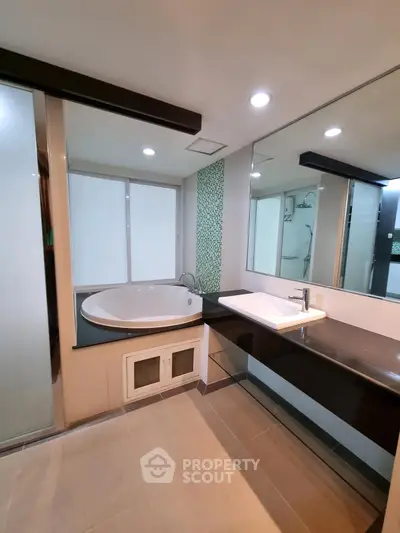 Luxurious bathroom with modern fixtures and spacious bathtub in a stylish real estate property.