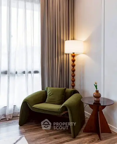 Stylish living room corner with modern green chair and elegant floor lamp.