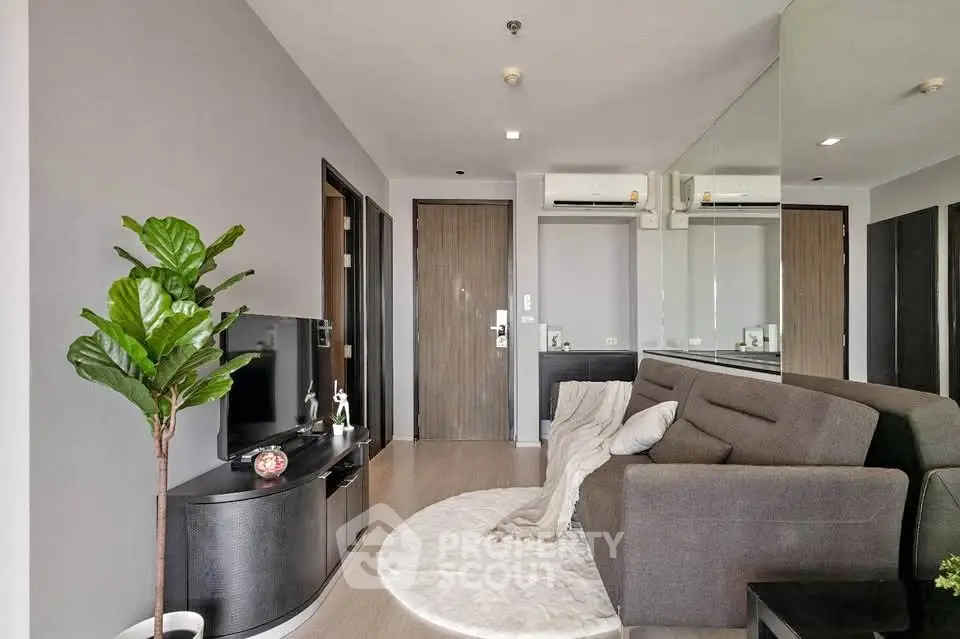 Modern living room with sleek design, featuring a cozy sofa, TV unit, and stylish decor.