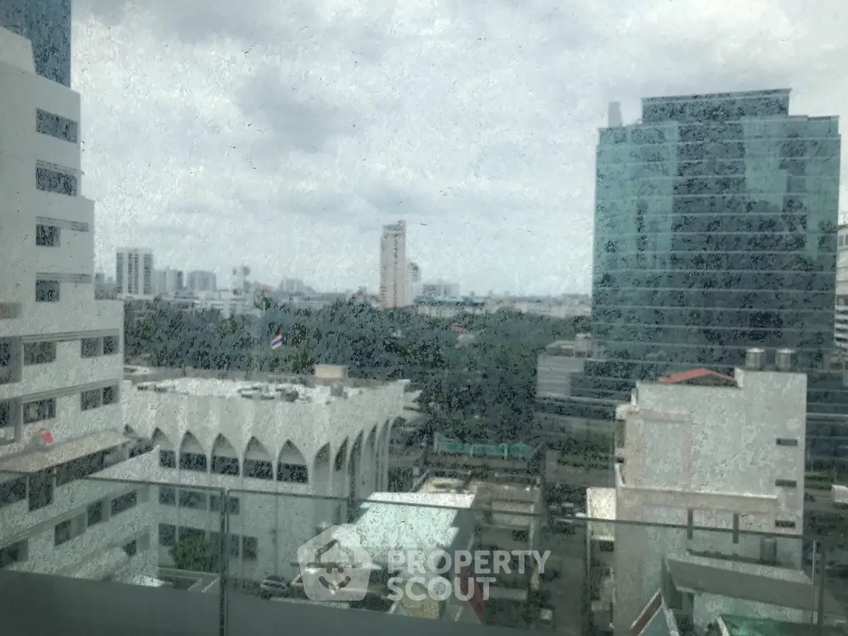 Stunning cityscape view from high-rise building window showcasing urban skyline.