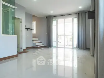 Spacious modern living room with large windows and glossy tiled floors, perfect for natural light and open living.