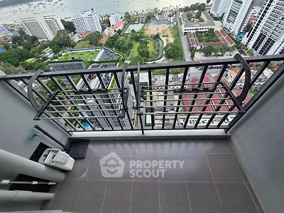 High-rise balcony with stunning city and sea view, perfect for urban living.