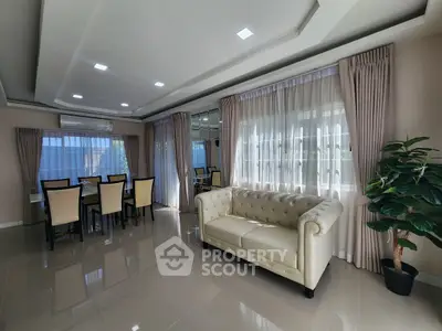 Elegant living room with modern dining area and stylish decor