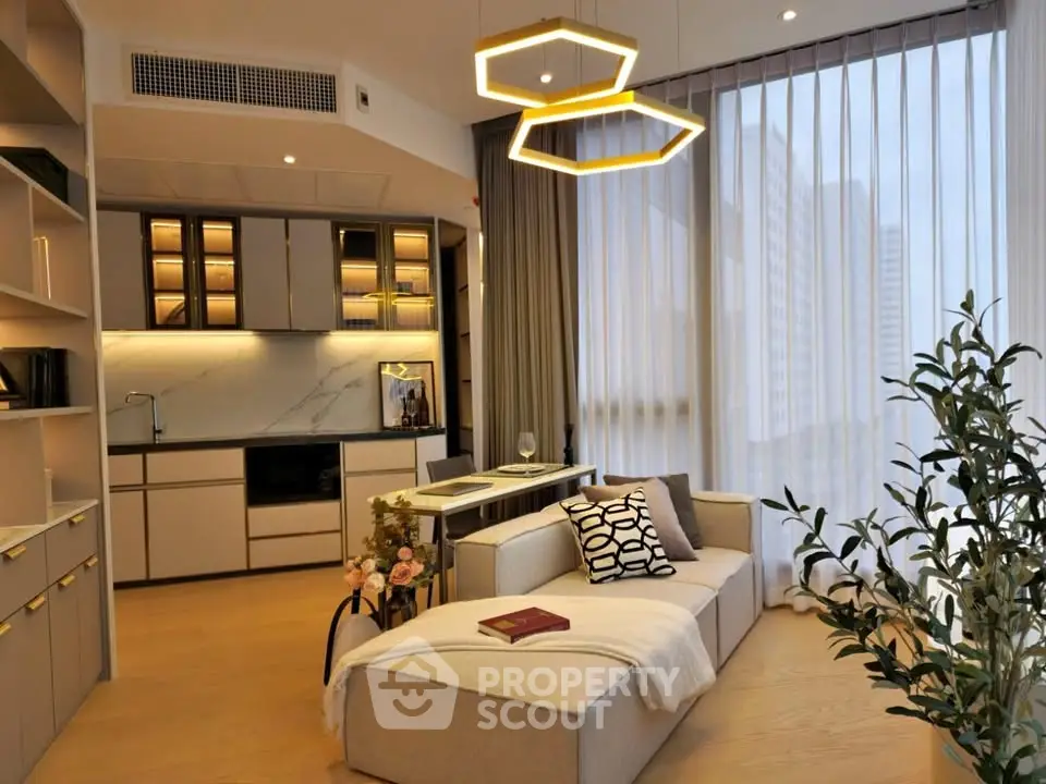 Modern living room with stylish lighting and open kitchen layout in a high-rise apartment.