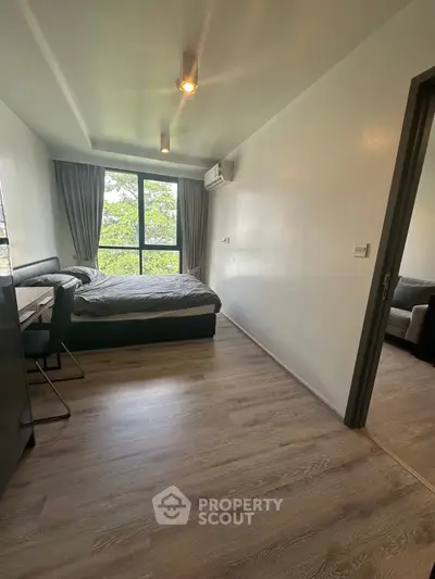Modern bedroom with large window and stylish decor