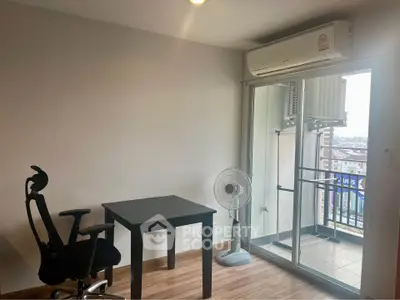 Modern study room with balcony access and city view, featuring sleek desk and ergonomic chair.