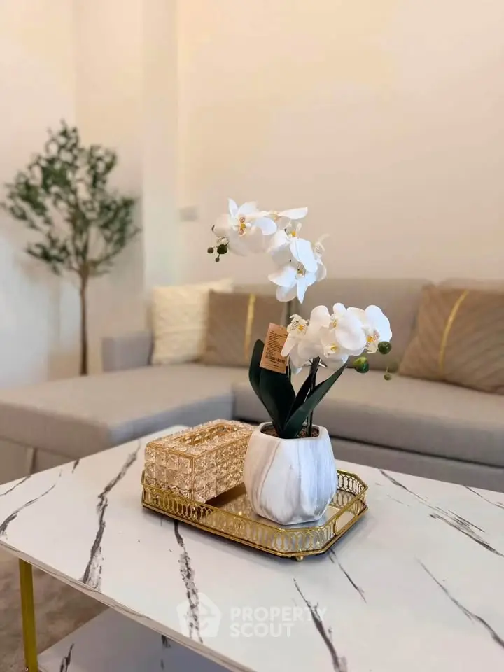 Elegant living room with modern decor and stylish marble coffee table.