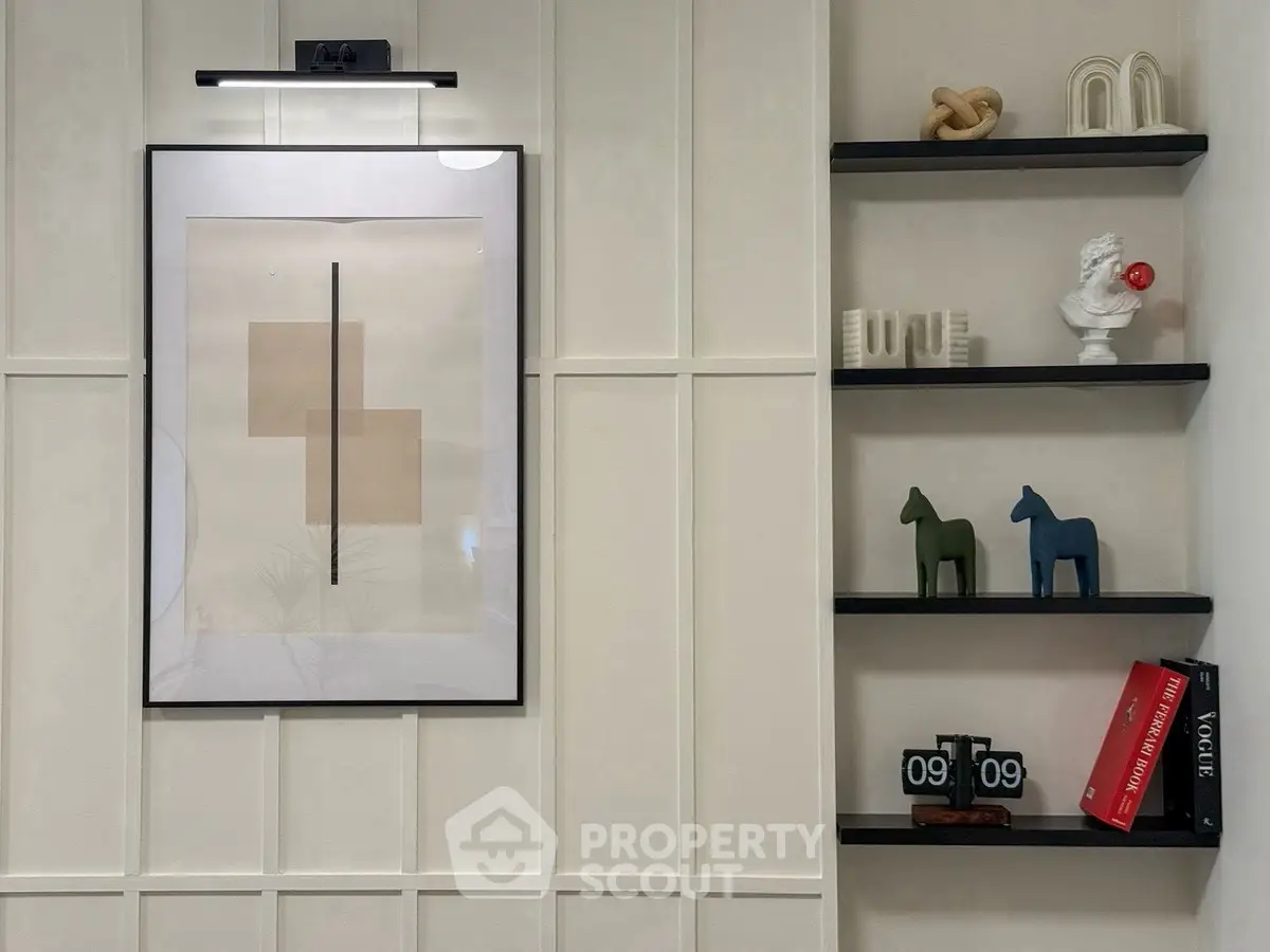 Stylish modern interior with framed art and decorative shelves in a chic living space.