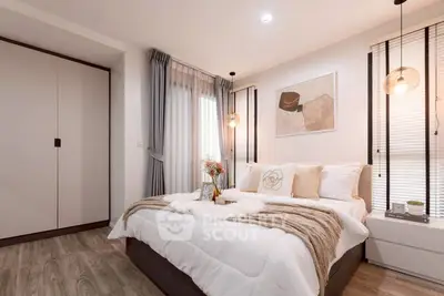 Elegant bedroom with modern decor, cozy bedding, and stylish lighting in a contemporary apartment.