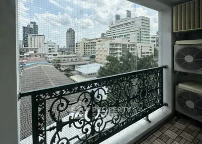 Charming balcony with city view and ornate railing in urban setting
