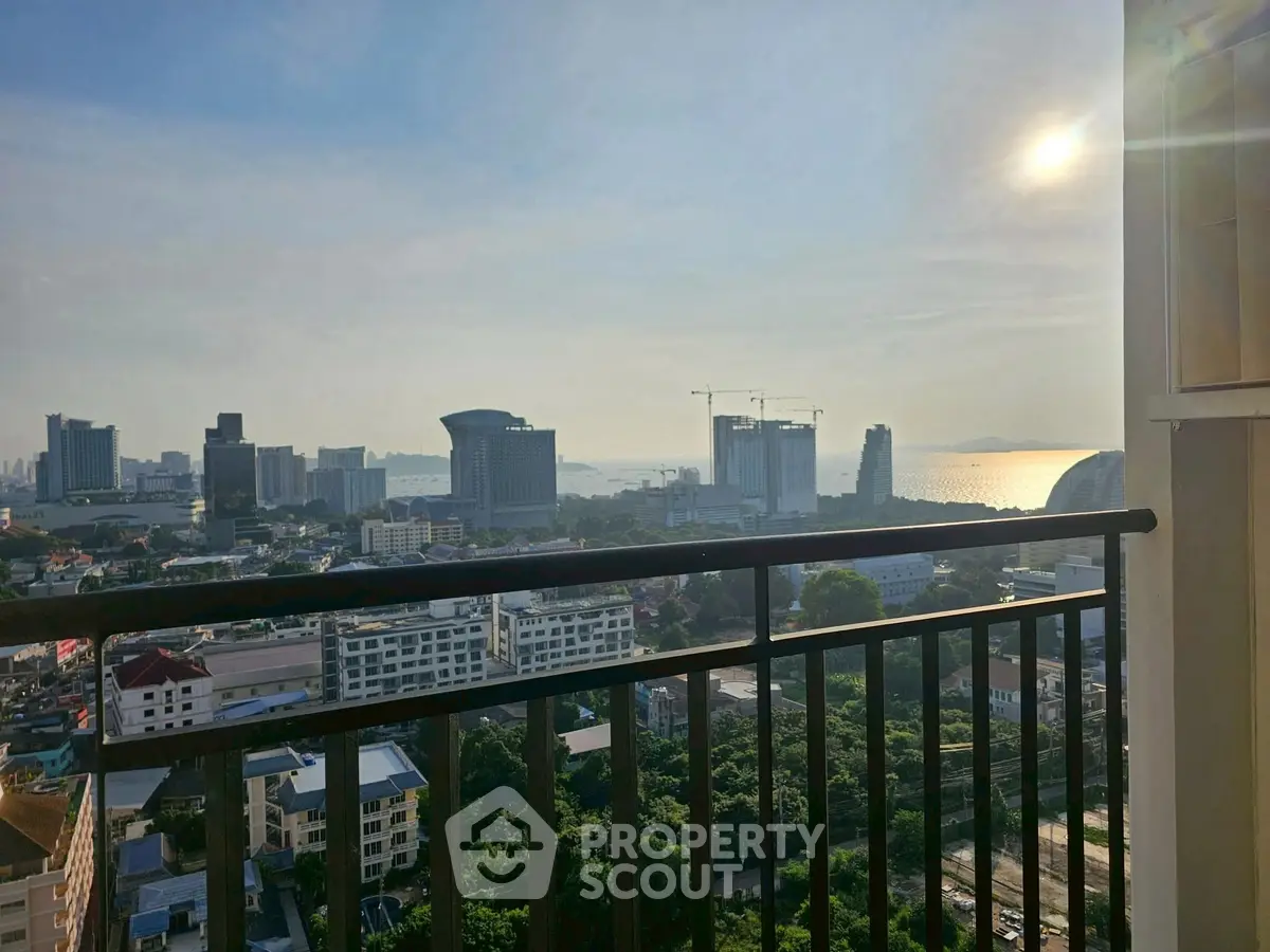 Stunning cityscape view from high-rise balcony at sunset, perfect for urban living.