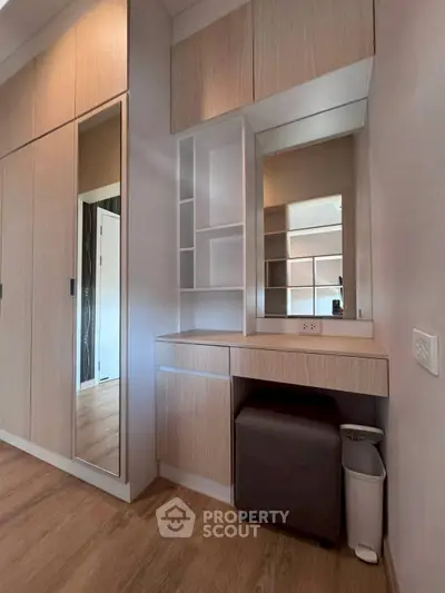 Modern bedroom with built-in wardrobe and vanity in sleek wood finish