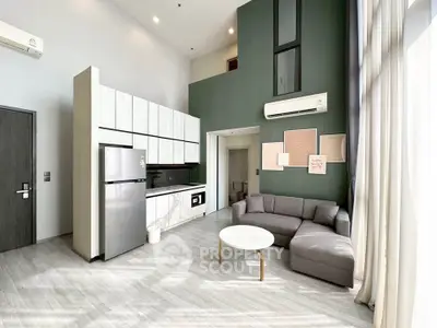 Modern living room with high ceiling, stylish furniture, and open kitchen layout in a contemporary apartment.