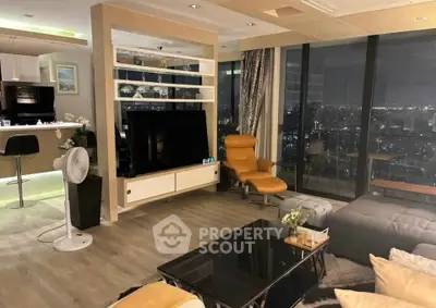 Luxurious modern living room with city view, stylish furniture, and open kitchen layout.