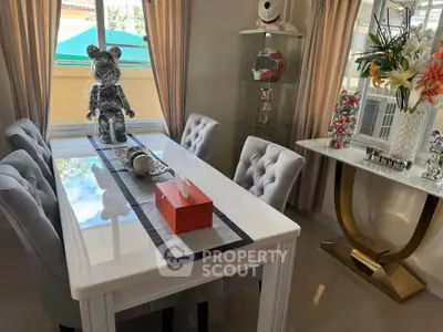 Elegant dining room with plush chairs and decorative accents in a modern home.