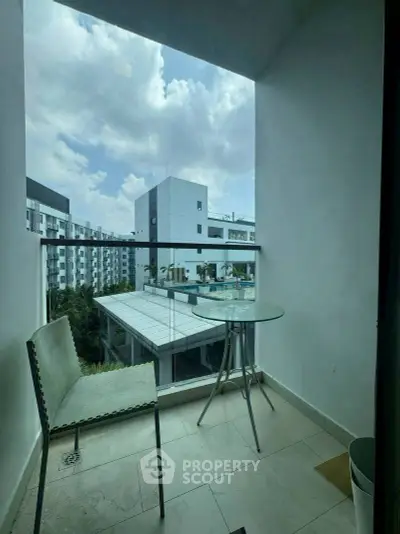 Charming balcony with modern furniture and city view, perfect for relaxation and enjoying the skyline.