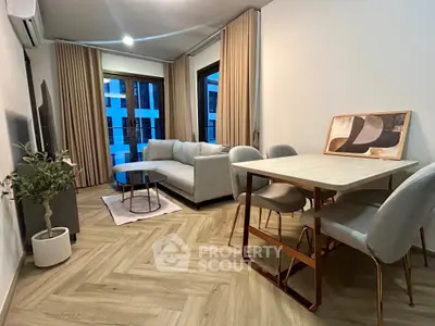 Modern living room with stylish furniture and large windows in a contemporary apartment.