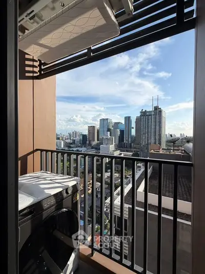 Stunning city view from a high-rise balcony with modern laundry setup.