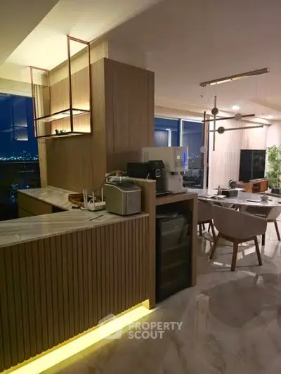 Luxurious open-layout kitchen with modern appliances and elegant dining area.