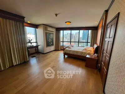 Spacious bedroom with city view and elegant wooden flooring