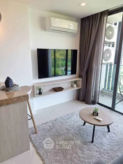Modern living room with sleek TV setup and balcony view