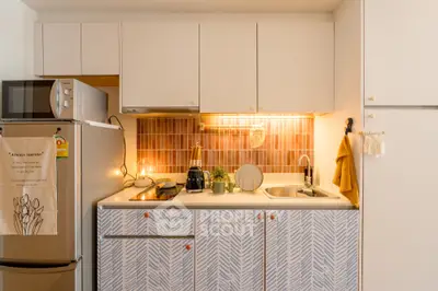 Charming kitchen with modern appliances and stylish cabinetry in cozy apartment