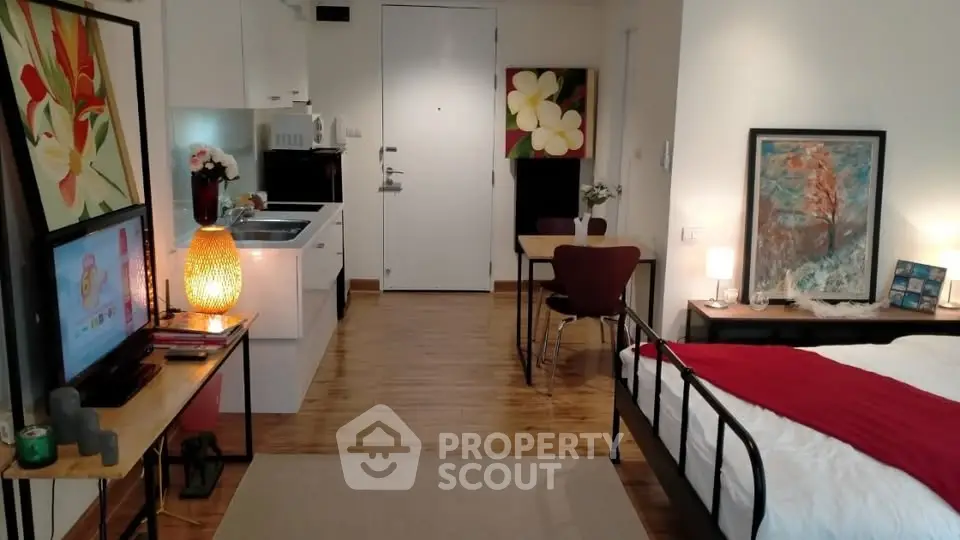 Chic studio apartment with modern decor, open kitchen, and cozy living area.