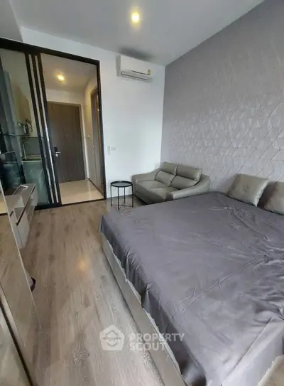 Modern bedroom with sleek design and cozy ambiance, featuring a comfortable bed and stylish decor.