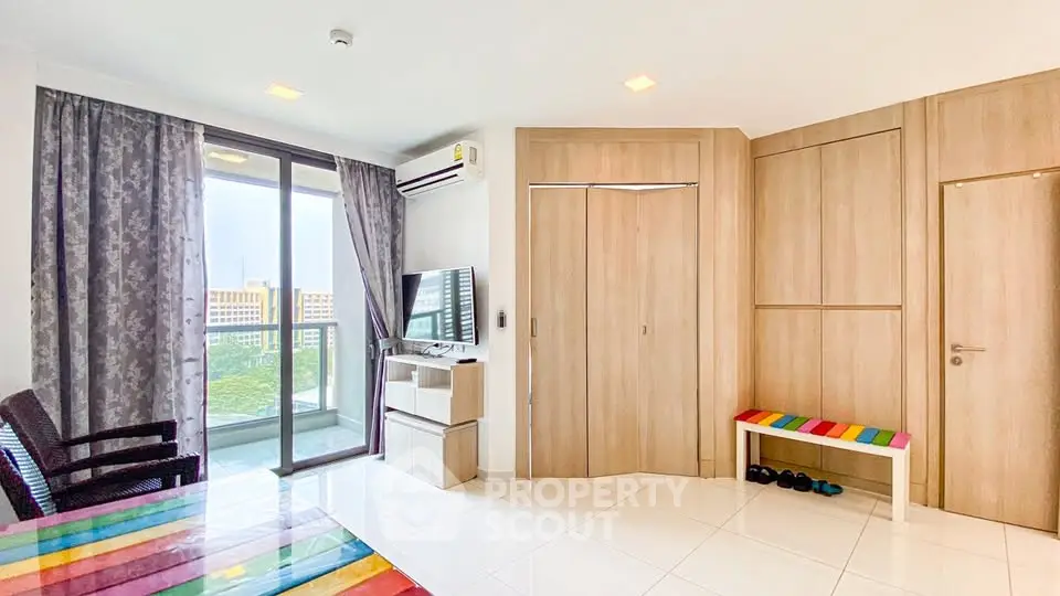 Modern living room with balcony and colorful decor in a bright apartment