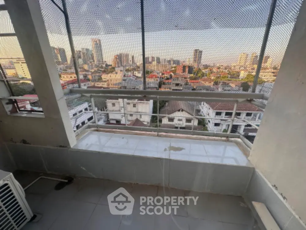 Stunning cityscape view from high-rise balcony with urban skyline