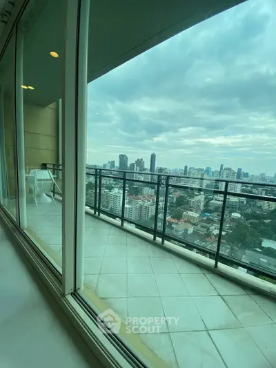Stunning high-rise balcony with panoramic city views and spacious tiled flooring.