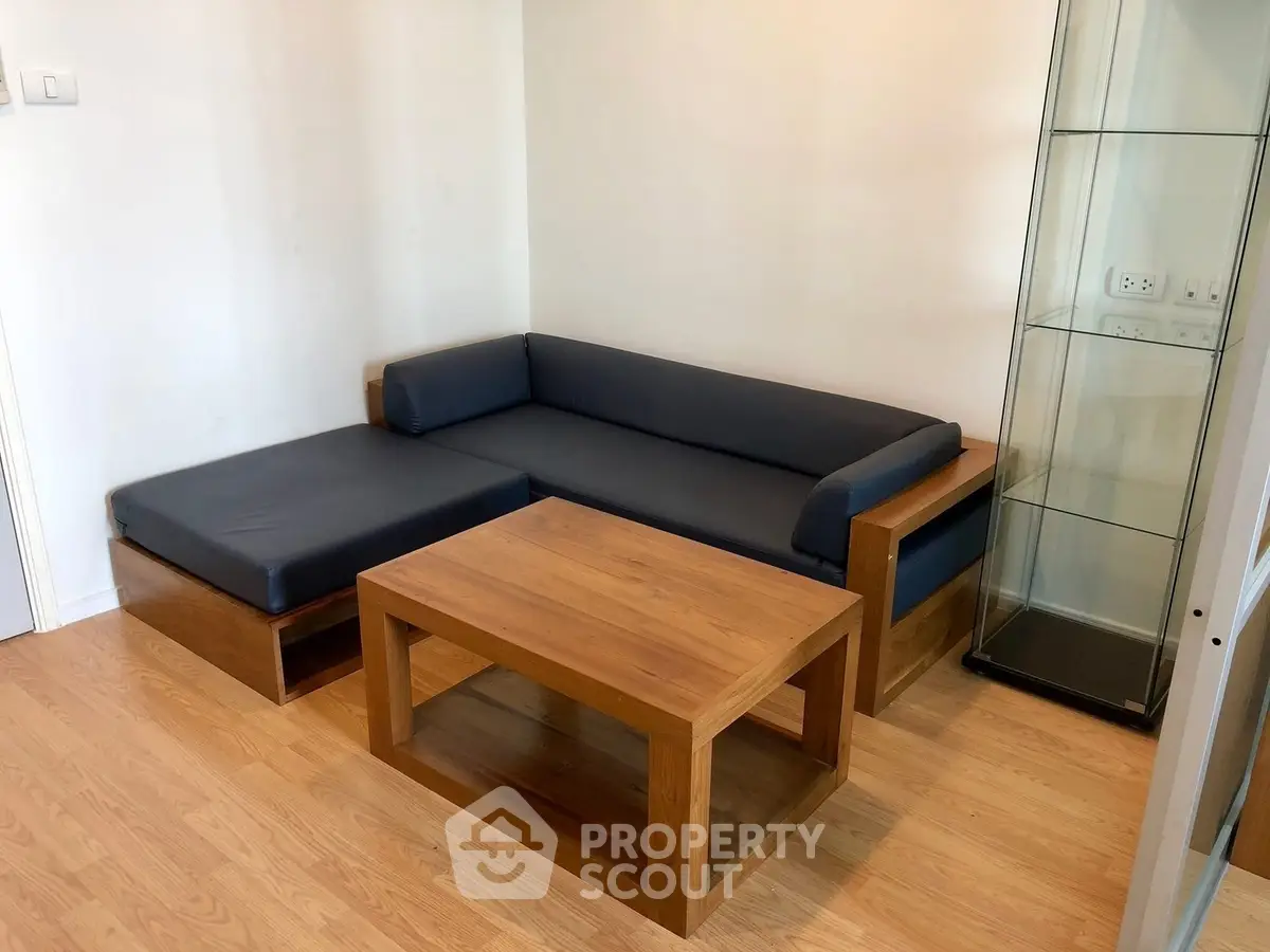 Modern living room with wooden furniture and glass display cabinet