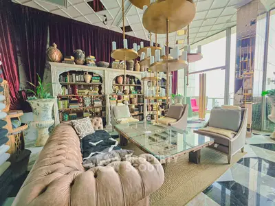 Luxurious living room with elegant decor and floor-to-ceiling windows offering stunning views.