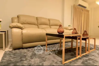 Luxurious living room with plush leather sofa and modern coffee table, perfect for relaxation and entertaining.
