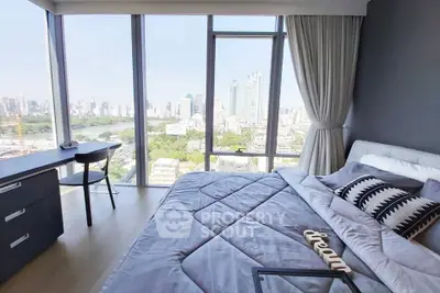 Luxurious bedroom with stunning city view and modern decor in high-rise apartment.