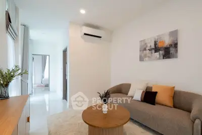 Modern living room with stylish decor and air conditioning in a bright apartment.