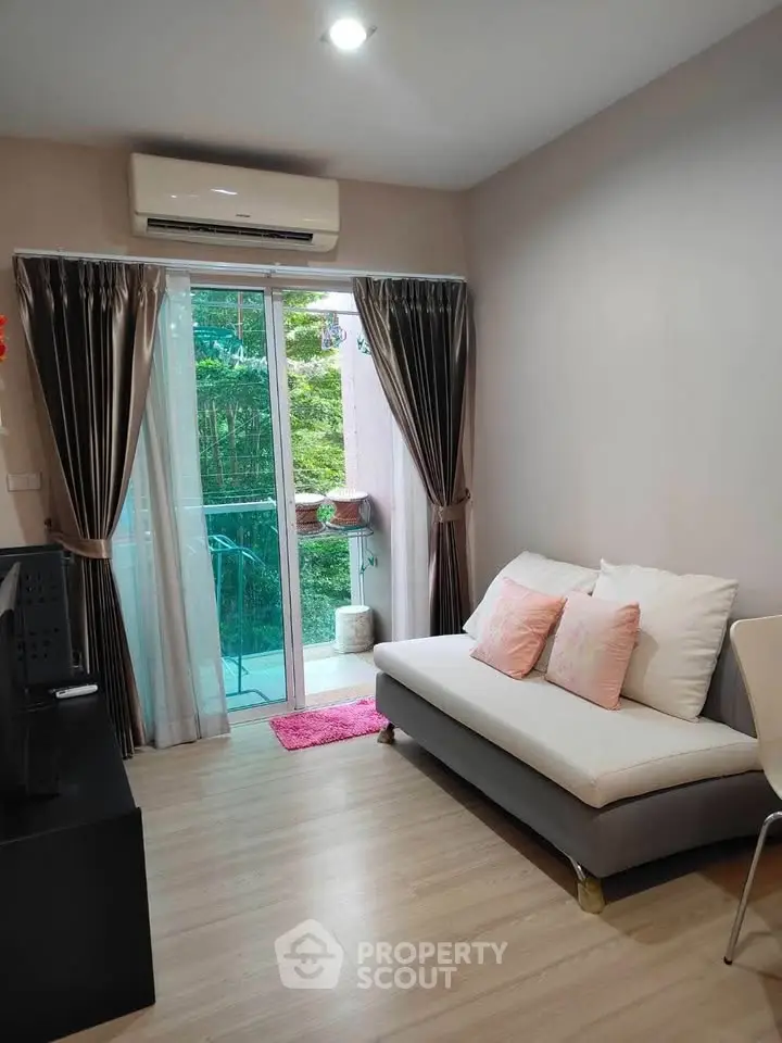 Cozy living room with modern decor and balcony view, perfect for relaxation and comfort.