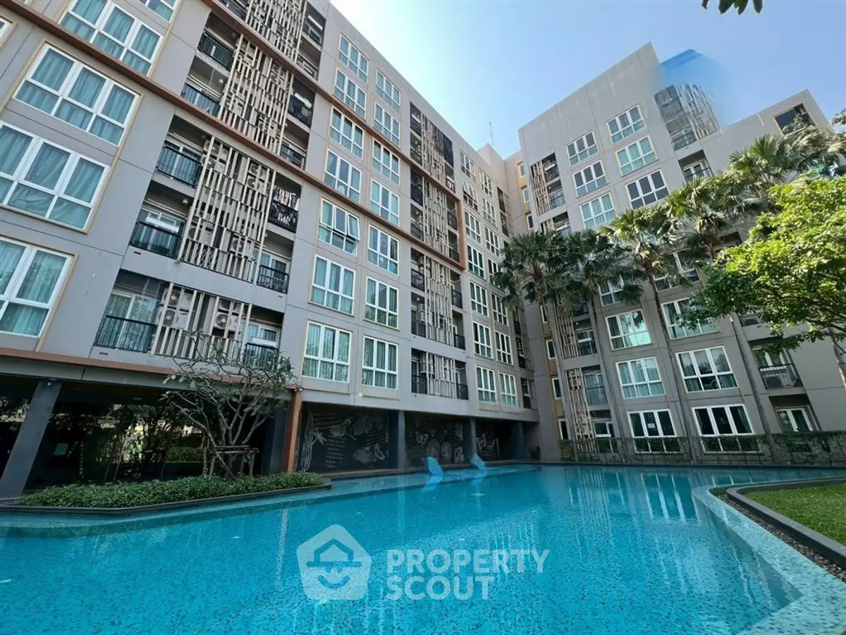 Modern apartment building with pool and lush greenery, perfect for urban living.