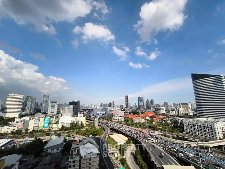 Stunning cityscape view showcasing modern skyscrapers and bustling highways under a clear blue sky.