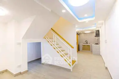 Modern interior with sleek staircase and open kitchen layout