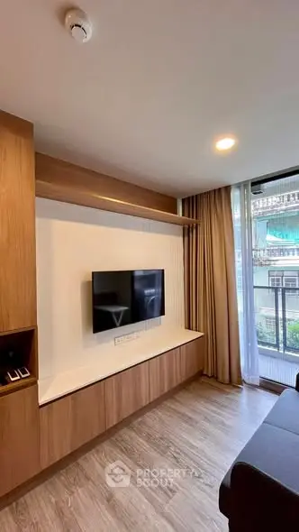Modern living room with wall-mounted TV and large window view