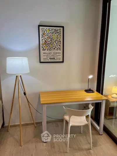 Modern study area with sleek desk, stylish lamp, and elegant decor.