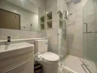 Modern bathroom with glass shower and sleek fixtures