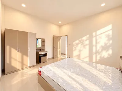 Spacious bedroom with modern furniture and natural light