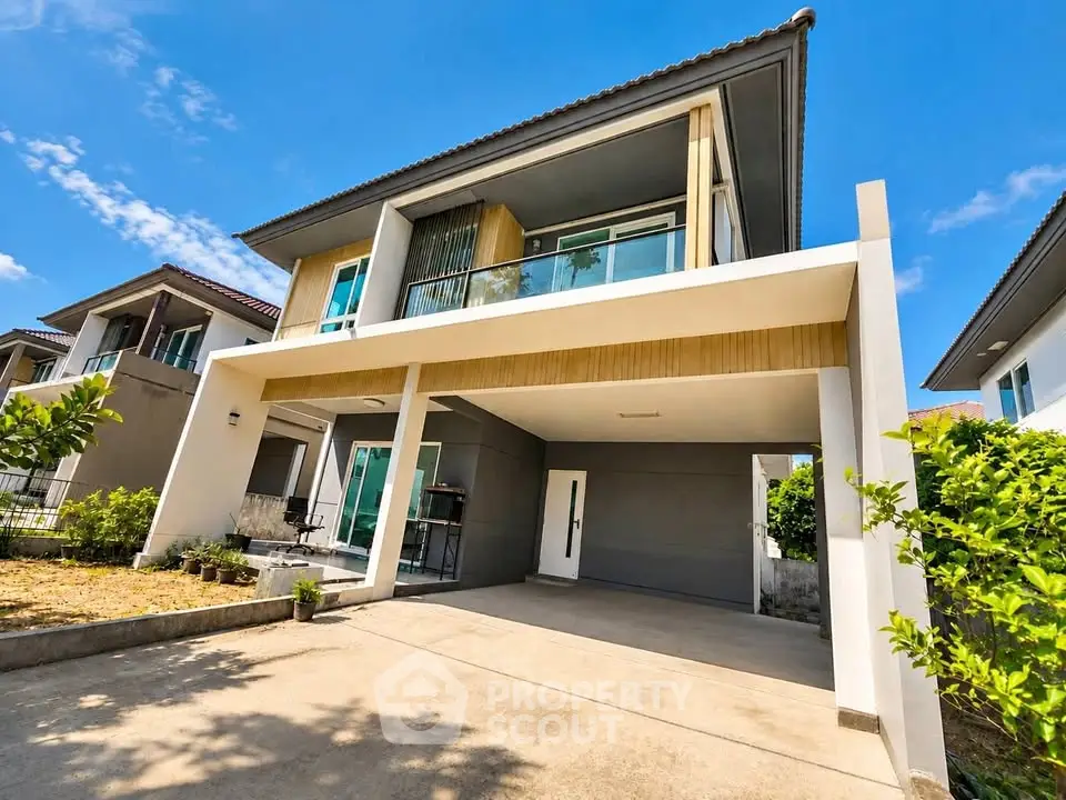 Modern two-story house with spacious driveway and lush greenery, perfect for family living.