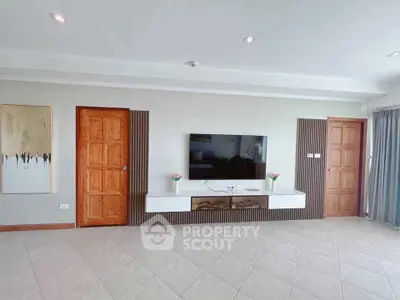 Spacious modern living room with sleek TV setup and elegant decor