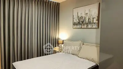 Cozy bedroom with modern decor and cityscape artwork, featuring elegant curtains and soft lighting.