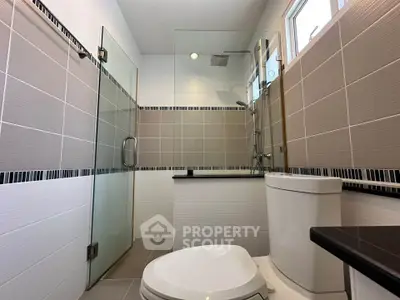 Modern bathroom with glass shower and sleek tile design