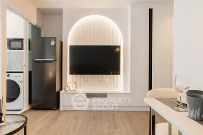 Modern living room with sleek TV setup and stylish kitchen appliances