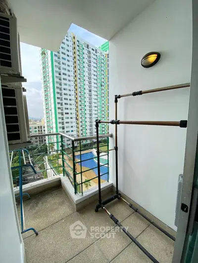 Cozy balcony with city view, perfect for relaxing and enjoying the skyline.